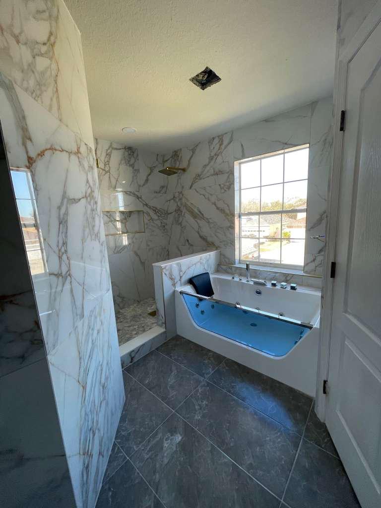 After: bright marble bathroom with modern fixtures