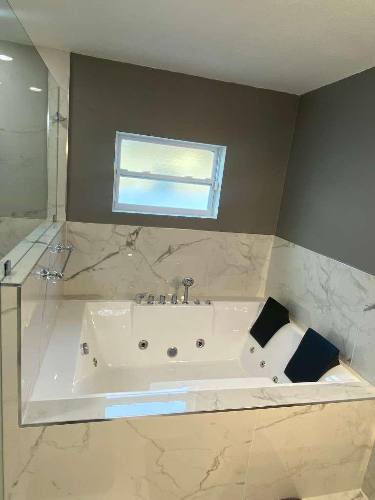 Master bathroom renovation with marble walk-in shower and rainfall showerhead